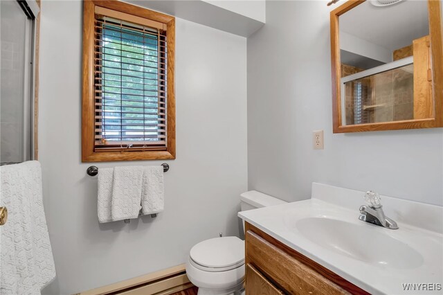 bathroom featuring baseboard heating, vanity, and toilet