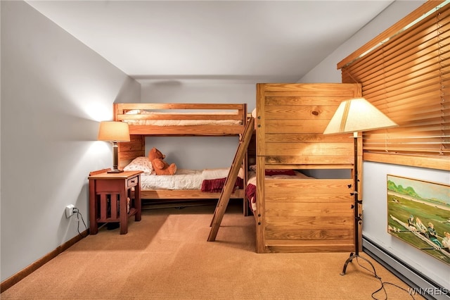 carpeted bedroom featuring baseboard heating