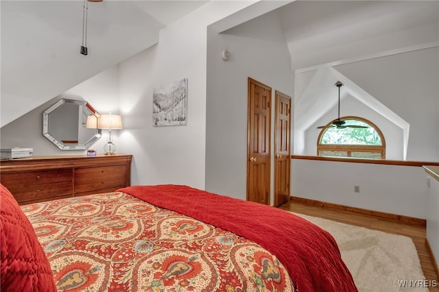 bedroom featuring hardwood / wood-style floors and lofted ceiling