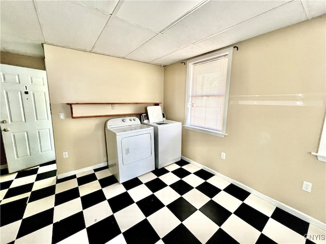 clothes washing area with washing machine and dryer and tile patterned floors