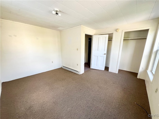 unfurnished bedroom with carpet flooring and baseboard heating