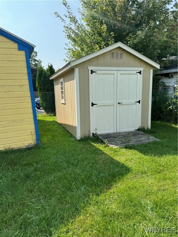 view of outdoor structure with a lawn