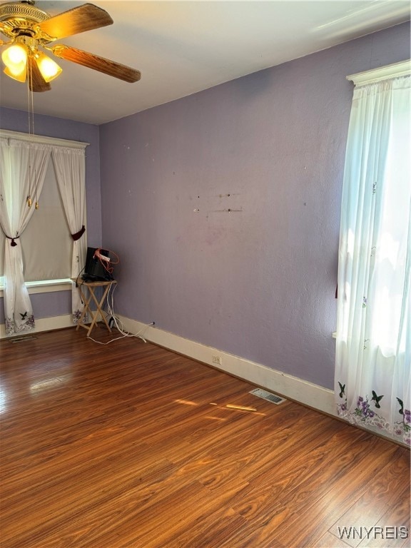 unfurnished room featuring ceiling fan and hardwood / wood-style flooring