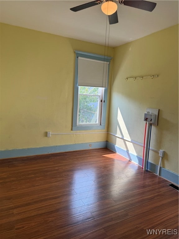 empty room with ceiling fan and hardwood / wood-style flooring