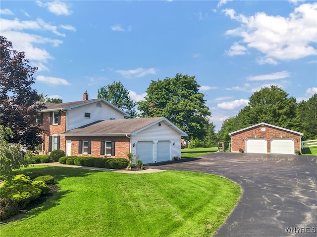 view of front of property with a garage and a front lawn