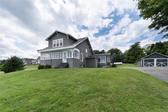 view of front facade featuring a front yard, an outdoor structure, and a garage