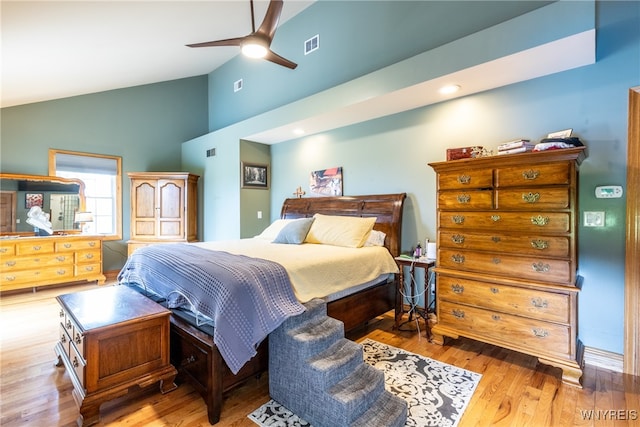 bedroom with ceiling fan, light wood-type flooring, and high vaulted ceiling