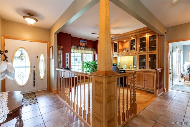 tiled foyer featuring ceiling fan and a healthy amount of sunlight