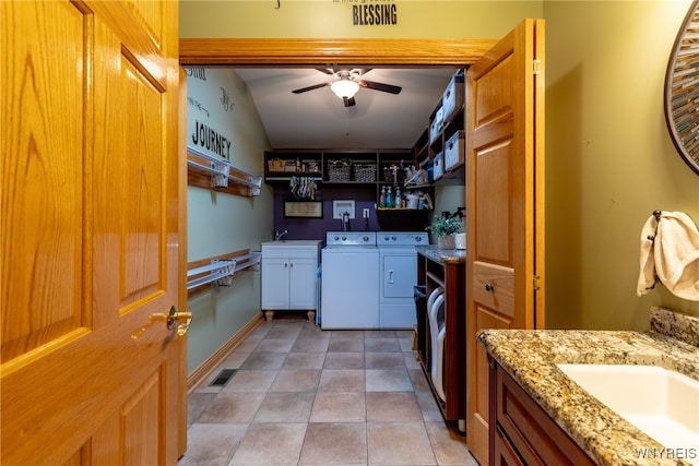 washroom with washer and clothes dryer, sink, cabinets, ceiling fan, and light tile patterned flooring