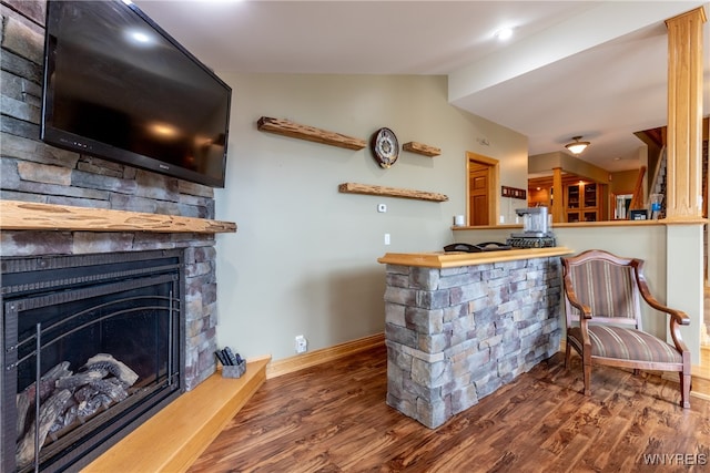 bar with hardwood / wood-style flooring and a fireplace