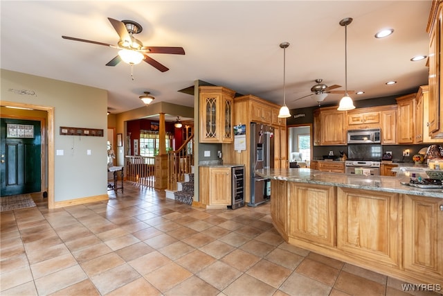 kitchen featuring ceiling fan, appliances with stainless steel finishes, light tile patterned floors, and plenty of natural light