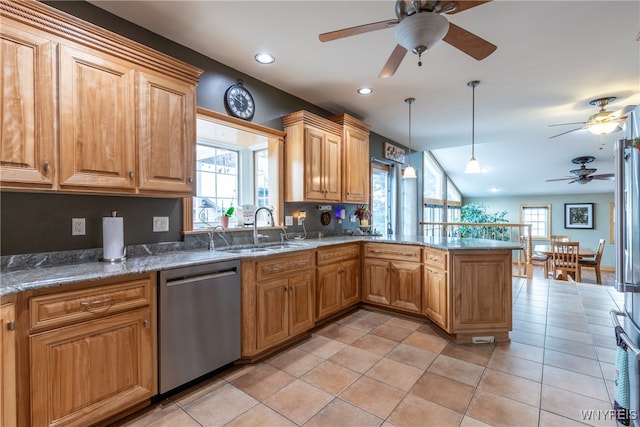 kitchen featuring ceiling fan, kitchen peninsula, stainless steel dishwasher, and a healthy amount of sunlight