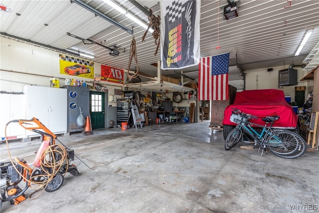 garage with a workshop area and a garage door opener