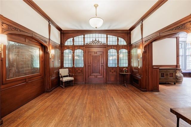 entrance foyer with crown molding and hardwood / wood-style flooring