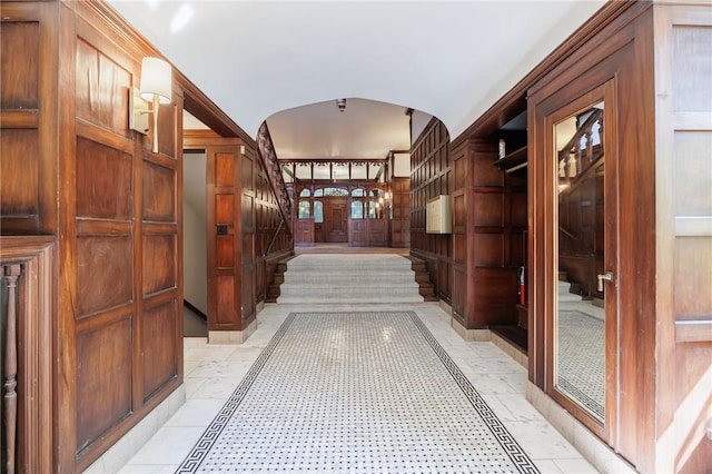 935 E Ave, Rochester, NY 14607 - hallway featuring inlaid floor details, arched walkways, and stairs