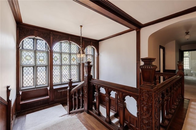 935 E Ave, Rochester, NY 14607 - stairs featuring arched walkways, crown molding, wood finished floors, and a chandelier