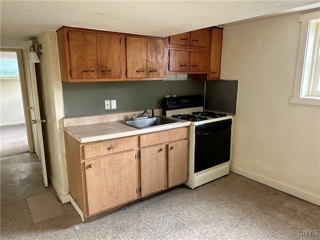 kitchen featuring light tile patterned flooring, sink, and white gas range