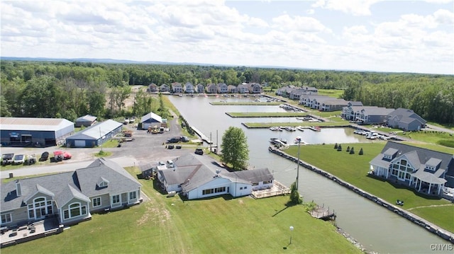 bird's eye view with a wooded view, a water view, and a residential view