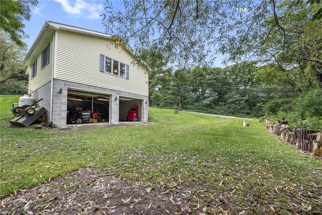 back of property with a yard and a garage