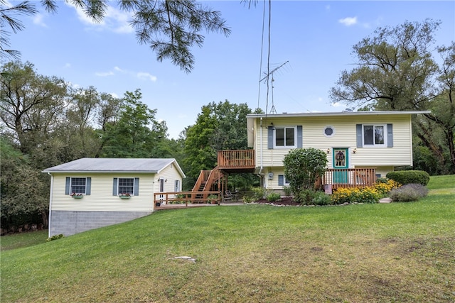 back of property featuring a yard and a wooden deck