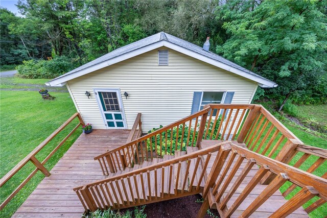 wooden deck featuring a lawn