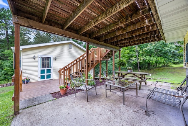 view of patio with an outdoor fire pit and a deck