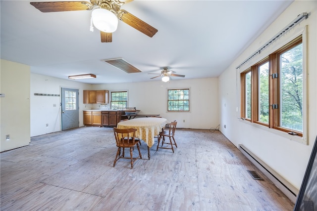 dining space featuring ceiling fan and baseboard heating