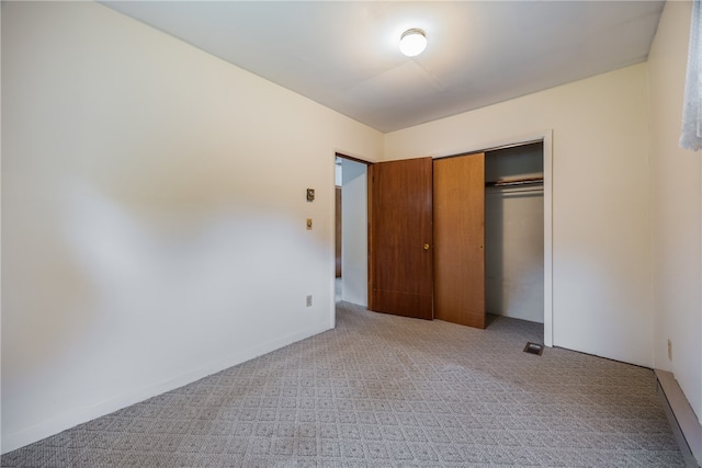 unfurnished bedroom with a closet and carpet