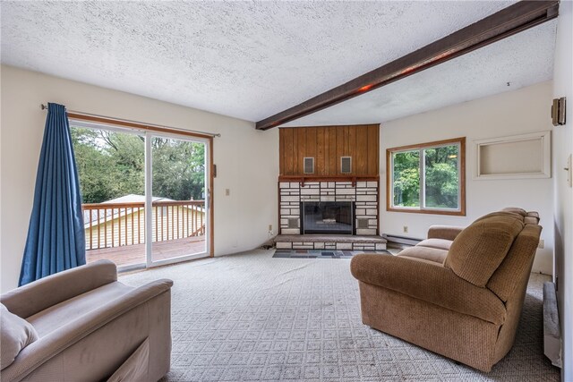 carpeted living room with beam ceiling, a textured ceiling, baseboard heating, and a fireplace