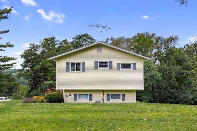 exterior space with a wooden deck and a front yard