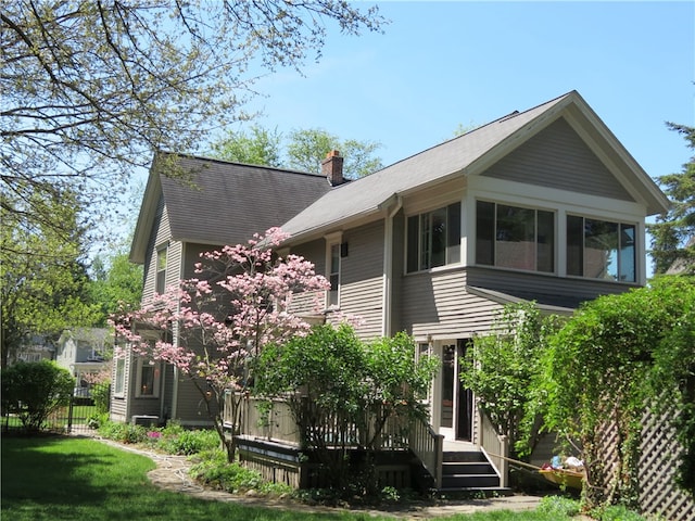 rear view of property featuring a deck