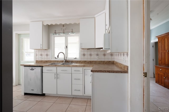 kitchen with white cabinets, a sink, stainless steel dishwasher, and light tile patterned floors