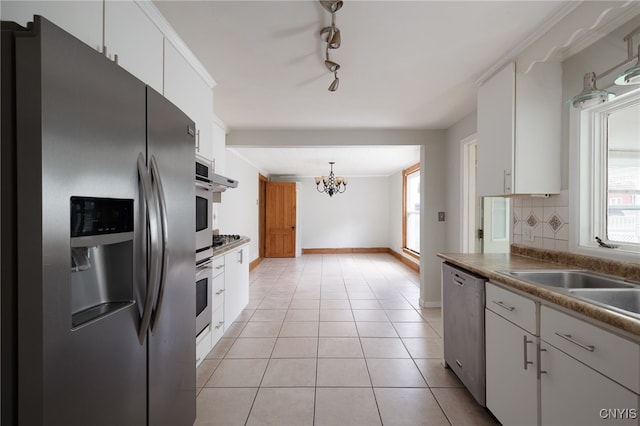 kitchen featuring light tile patterned floors, stainless steel appliances, white cabinets, ornamental molding, and tasteful backsplash