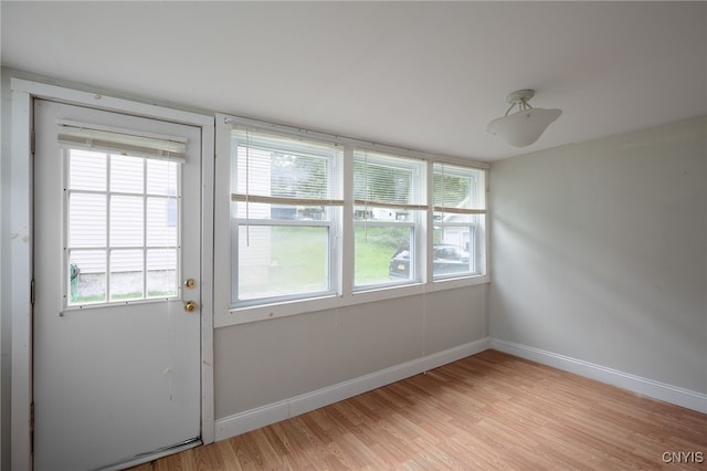 interior space featuring light wood-style flooring and baseboards