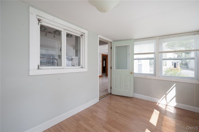 empty room featuring baseboards and wood finished floors