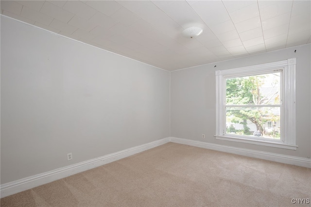 empty room with carpet and baseboards