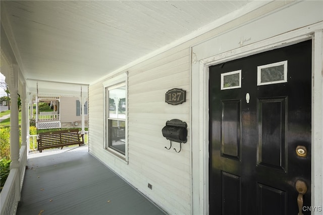 doorway to property featuring covered porch