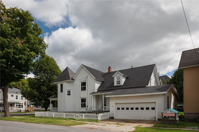 view of front of property with an attached garage, fence, driveway, roof with shingles, and a chimney