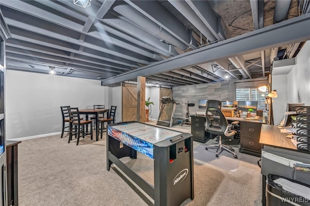 rec room featuring light colored carpet and a barn door