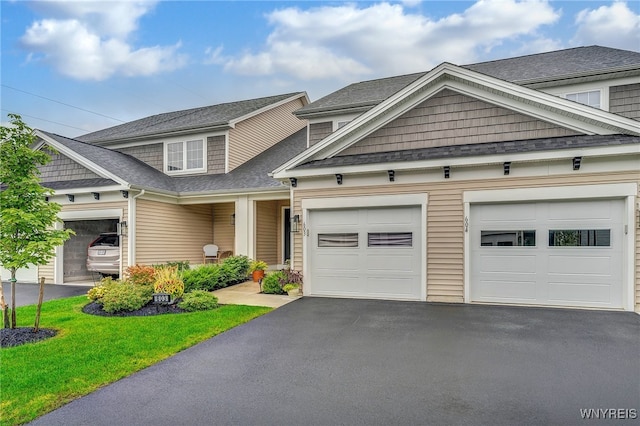 craftsman-style house with a front yard and a garage