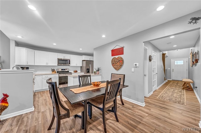 dining space with light hardwood / wood-style flooring