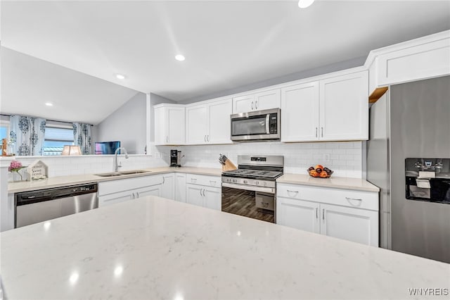 kitchen featuring appliances with stainless steel finishes, sink, and white cabinetry