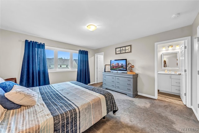 carpeted bedroom featuring connected bathroom