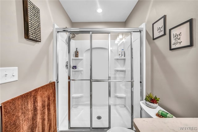 bathroom featuring a shower with shower door