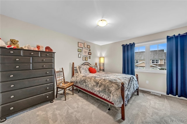 bedroom featuring light carpet