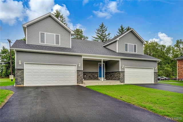 view of front of house with a garage and a front lawn