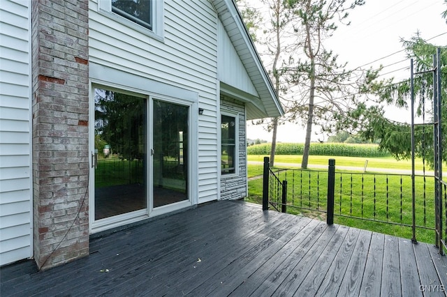 wooden deck with a lawn