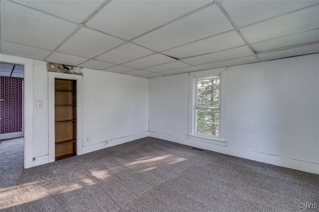 unfurnished room with carpet and a paneled ceiling