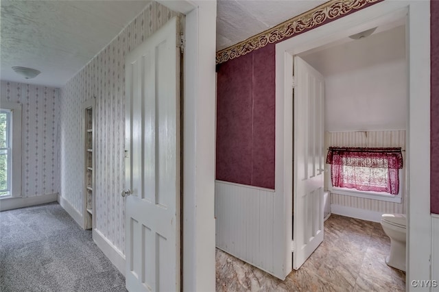 hall with light tile patterned floors