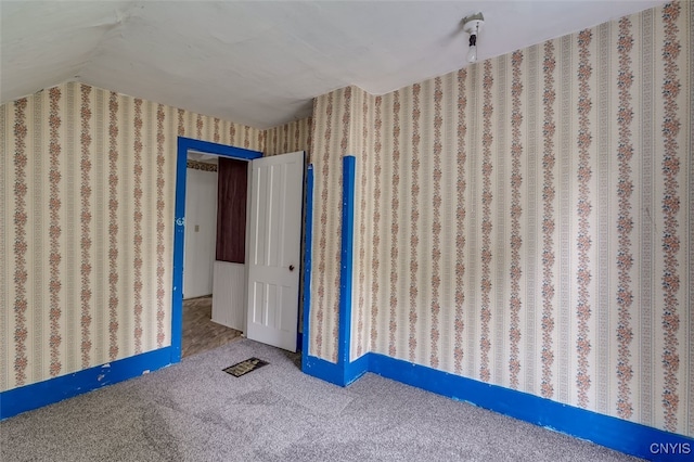 unfurnished bedroom with carpet floors and lofted ceiling